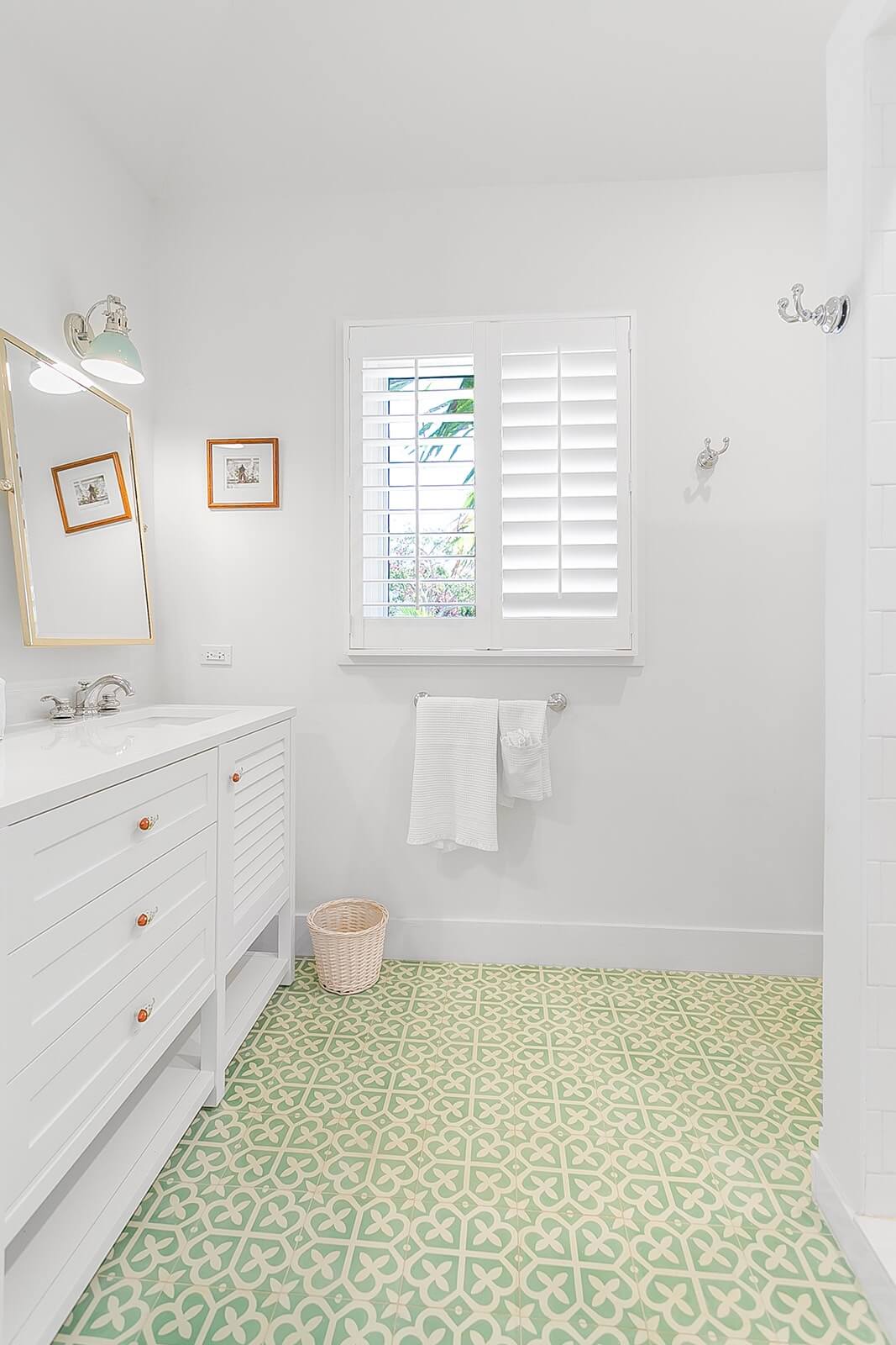Bathroom with green patterned tile floor and white vanity Bakari House Great Exuma Bahamas