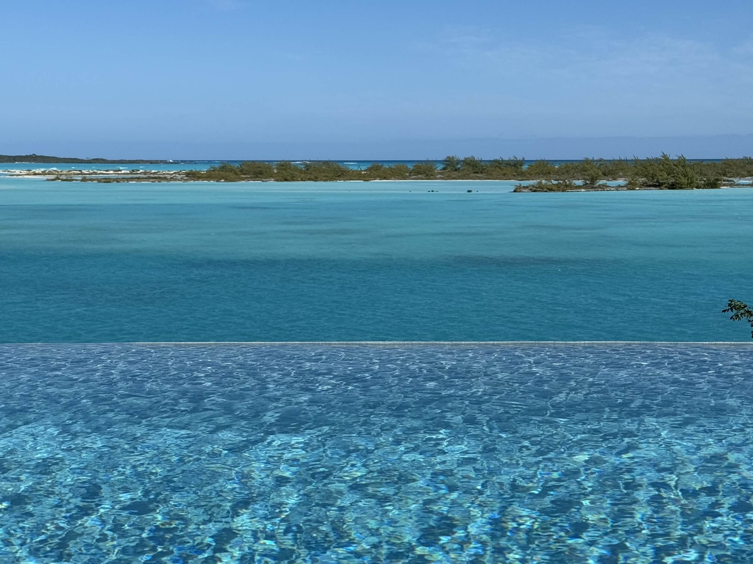 Infinity pool overlooking the turquoise cays of Great Exuma Bahamas