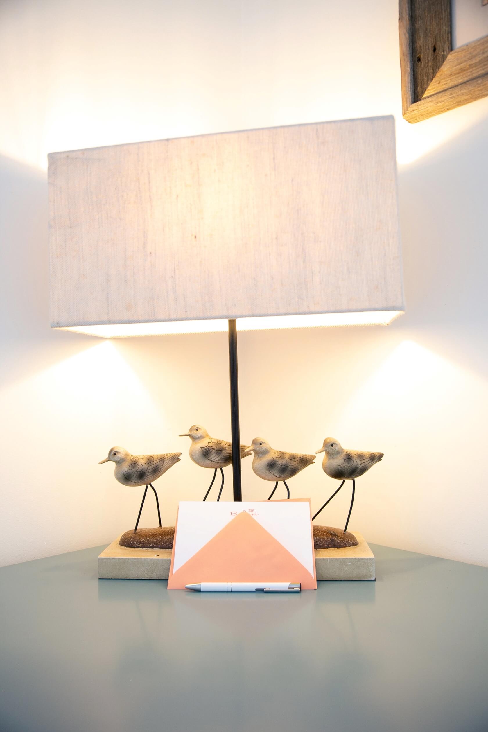 Shorebird figurine table lamp on a bedroom nightstand Bakari House Great Exuma Bahamas